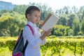 Girl in the open air, reading a book and eating a red apple Royalty Free Stock Photo