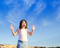 Girl open arms outdoor under blue sky