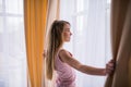 Girl open windows blinders in her room Royalty Free Stock Photo