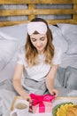 girl opening present box in bed Royalty Free Stock Photo