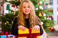 Girl opening present on Christmas day Royalty Free Stock Photo