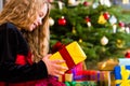 Girl opening present on Christmas day Royalty Free Stock Photo