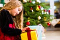 Girl opening present on Christmas day Royalty Free Stock Photo