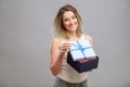 Girl opening a present isolated Royalty Free Stock Photo