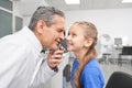 Girl opening widely eyes while oculist checking eyesight