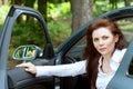 Girl opens the door exiting the car Royalty Free Stock Photo