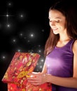 The girl opens the gift Royalty Free Stock Photo
