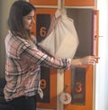 Girl opens a locker in the store and puts the eco bag