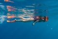 Girl in orange swimming mask and flippers dive in deep sea Royalty Free Stock Photo