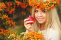 Girl in Orange wreath with Red Apple in hand Royalty Free Stock Photo