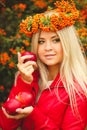 Girl in Orange wreath with Red Apple in hand Royalty Free Stock Photo