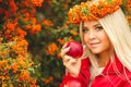 Girl in Orange wreath with Red Apple in hand Royalty Free Stock Photo