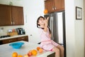 Girl with oranges in kitchen Royalty Free Stock Photo