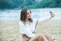 Girl outdoors texting on her mobile phone. Girl with phone. Portrait of a happy woman text sms message on her phone. Royalty Free Stock Photo