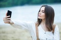 Girl outdoors texting on her mobile phone. Girl with phone. Portrait of a happy woman text sms message on her phone. Royalty Free Stock Photo