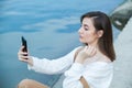 Girl outdoors texting on her mobile phone. Girl with phone. Portrait of a happy woman text sms message on her phone. Royalty Free Stock Photo