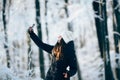 Girl outdors in the forest taking photo with phone (selfie)