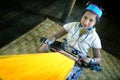 girl from the Padaung tribe, the people of Karen with copper rings around his neck, working on a l Royalty Free Stock Photo