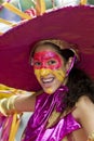 A girl with a painted face, wearing a large hat