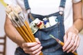 Girl painter holds a brush