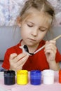 Girl paints her crafts