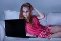 Girl in pajamas using laptop Royalty Free Stock Photo