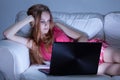 Girl in pajamas writing on forums