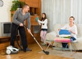 Girl with parents cleaning at home Royalty Free Stock Photo
