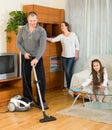 Girl with parents cleaning at home Royalty Free Stock Photo