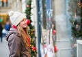 Girl on a Parisian street looking at shop windows