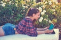 Girl on park bench playing with tablet Royalty Free Stock Photo