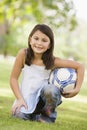 Girl in park holding football