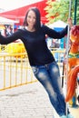 Girl in a park rides on the carousel