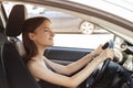 Girl parking,teenage driver looks in the mirror, puts the car