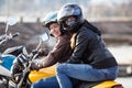 Girl a passenger sitting behind female motorcyclist on a bike, cheerful females riding on the urban street Royalty Free Stock Photo