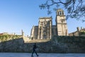 A girl passes in front of a church