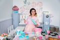 Girl pastry chef holding a rolling pin and a jar in her hands