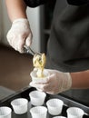 Girl pastry chef prepares muffins or cupcakes