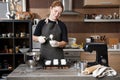 The girl pastry chef puts the dough for making a muffin or cupcake in a paper cup