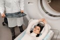 Girl patient is doing CT computed tomography x-ray scan of chest for examination of abdomen in a CT scanning room. CT Royalty Free Stock Photo