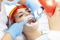 Girl patient at the reception at dentist. treatment of carious tooth. the girl lies on the dental chair with his mouth open. A den Royalty Free Stock Photo