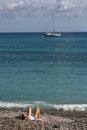 Girl on pebbles on beach