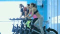 Girl pedaling on the simulator while four friends