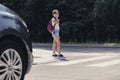 Girl on pedestrian crossing in front of a car talking over the phone