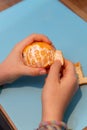 Girl peeling a clementine