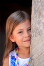 Girl peeping from behind pillar