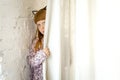 Girl peeping out from behind the curtains. A little girl with different emotions on her face Royalty Free Stock Photo