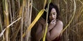 Girl in pensive pose amongst an Elephant Grass field