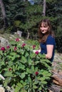 Girl and Peonies in the coniferous fores