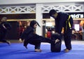 A girls performing a low kick during a aikido training session